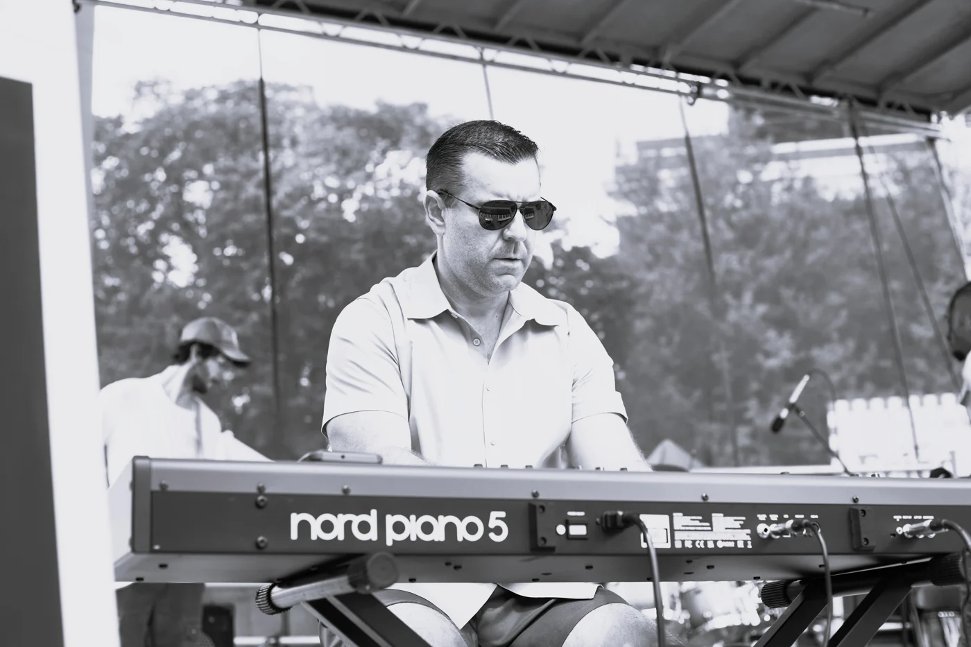 Brad Lemke playing his Nord keyboard on stage