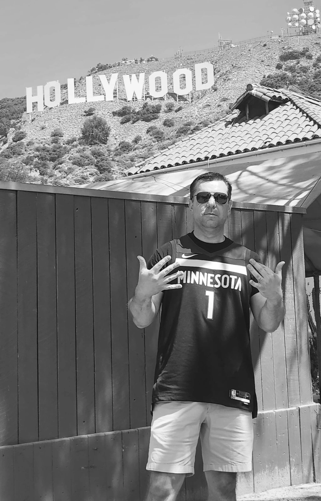 Band member beneath the Hollywood sign wearing a Minnesota jersey
