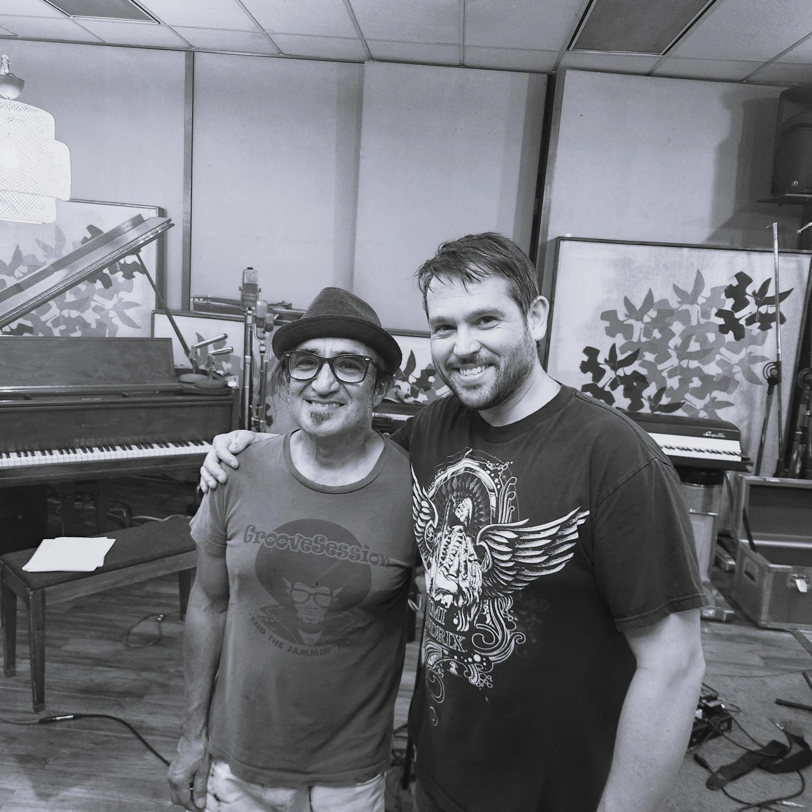 Two friends posing together in the recording studio